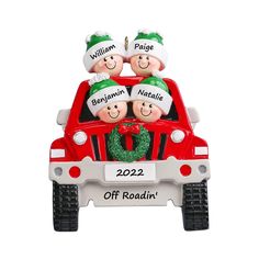 three people in the back of a red truck with christmas wreath on it's hood