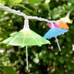 some colorful umbrellas hanging from a wire