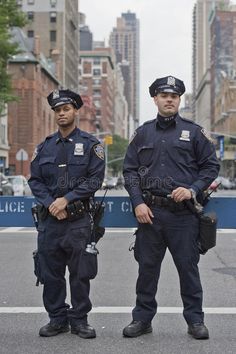 two police officers standing on the street in new york city, ny stock photos and images