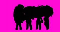 two people standing next to each other in front of a pink background with an animal