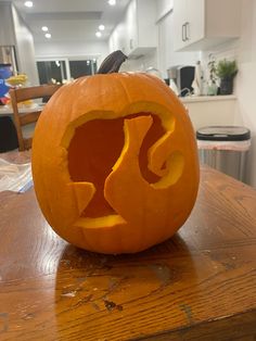 a carved pumpkin sitting on top of a wooden table