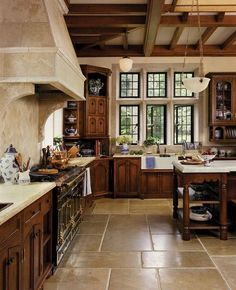 a kitchen filled with lots of wooden cabinets and counter tops