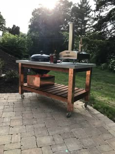 an outdoor bbq grill on a brick patio