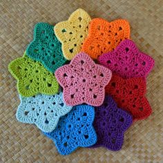 small crocheted doilies are arranged on the floor in different colors and sizes