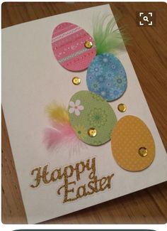 a close up of a greeting card on a wooden table with an easter egg design