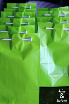 green paper bags lined up on a table