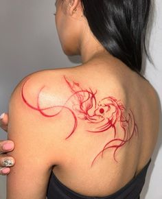 a woman with a red tattoo on her back