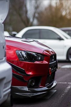 several cars parked in a parking lot next to each other