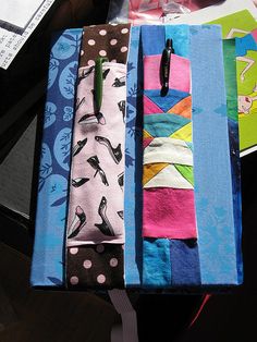 four different colored ties are lined up on a table