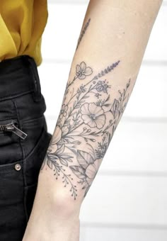 a woman's arm with flowers on it and the words suzie written in black ink