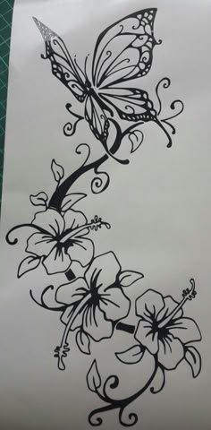 a butterfly and flowers tattoo design on white paper