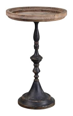 an old wooden table with metal legs and a round base on the top, against a white background