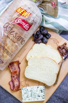 bread, bacon, cheese and olives on a cutting board