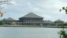 a large building sitting next to a body of water