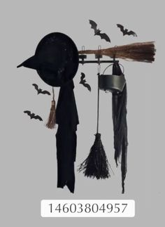 a group of bats hanging from the ceiling next to a hat and broom on a pole