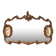 an ornate gold framed mirror with two cherubs on the front and back sides