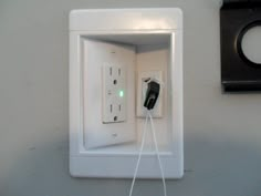 an electrical outlet in the wall with two wires attached to it and one light switch