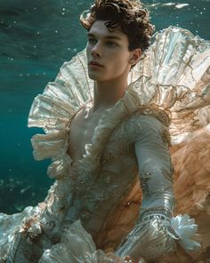 a woman in a white dress under water