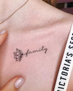 a woman's chest with the word family written on it and a butterfly tattoo