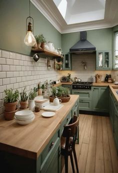 a kitchen filled with lots of green cabinets and counter top space next to a stove top oven