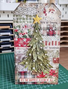 a card with a christmas tree on it sitting on top of a table next to a cutting board