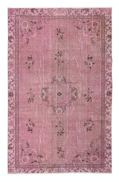 an antique rug with pink and black colors