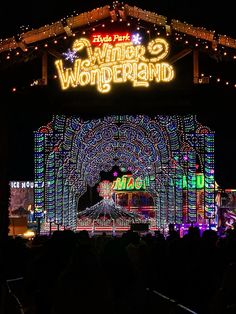 the entrance to winter wonderland lit up at night