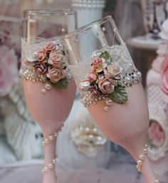 two wine glasses with flowers and pearls on them