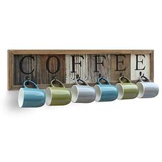 coffee mugs are lined up in front of a wooden sign with the word coffee on it