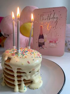 a birthday cake with lit candles on it