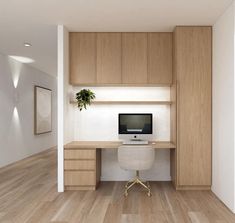 a desk with a computer on top of it in the middle of a room next to a plant