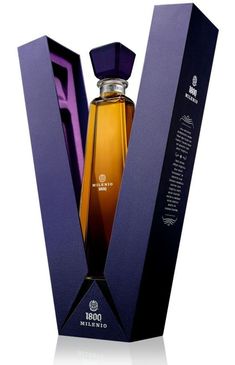 a bottle of perfume sitting inside of a purple box on top of a white surface