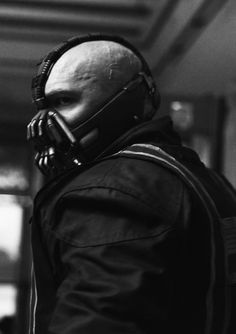 a man wearing a gas mask and carrying a cell phone