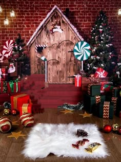 a room with christmas decorations and presents on the floor in front of a brick wall