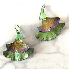 August 3, 2024 10am - 1pm Students will prepare 4 niobium gingko shapes and hammer a leafy texture into the metal. A combination of anodizing and sanding color puts colors right where you want them. The earrings will hang 1.75 inches. Class fee is $70 and includes 2”x 2” niobium. Gingko Leaf Earrings, Gingko Earrings, Gingko Necklace, Ginkgo Leaf Jewelry, Green Leaf-shaped Botanical Jewelry, Gingko Leaves, Flowers And Leaves, Leaf Earrings, Jewelry Shop