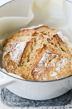 a loaf of bread in a white pot