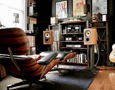 a living room filled with furniture and speakers