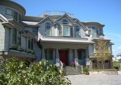 a large gray house with lots of windows