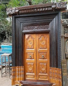 an old wooden door with carved designs on it's sides and the top part of its frame