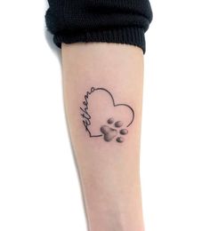 a dog paw and heart tattoo on the right arm, with an inscription that says i love