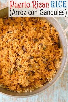 a close up of rice in a pan with the words puerto rican rice arroz con gandules