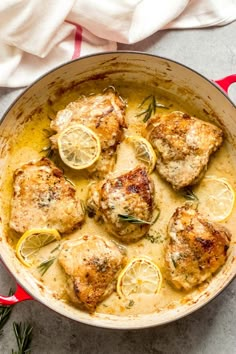 chicken thighs with lemons and herbs in a skillet