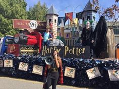 a woman standing in front of a float with people dressed as harry potter on it