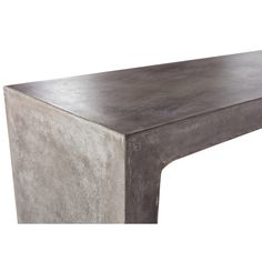 a large concrete table sitting on top of a white floor