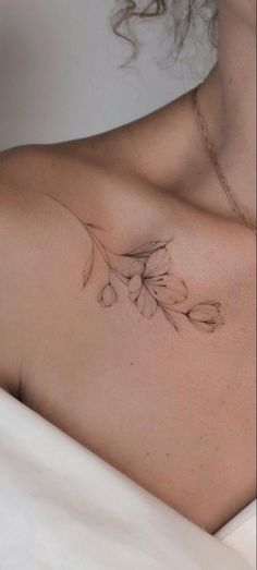 a woman with a flower tattoo on her chest