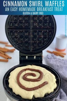 a waffle iron with cinnamon swirl waffles on top and gluten and dairy free