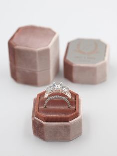 an engagement ring in a pink velvet box