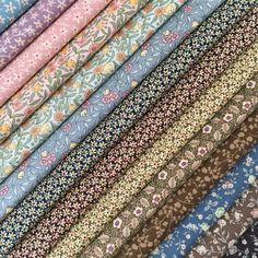 a bunch of different types of fabric on top of each other in various colors and patterns