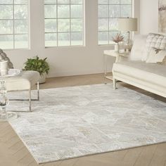 a living room filled with white furniture and lots of window sills on the windowsill