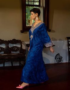 Editor's Note Featuring a deep blue self-woven kaftan with hand embroidery on yoke and cuffs. This elegant piece comes embellished with careful antique embroidery detailing. Color: Blue Fabric: Russian jacquard Component: Kaftan Fit: Relaxed Occasion: Resort and evening wear Care: Dry Clean Only About the Designer Paulmi & Harsh is a luxury prêt label inspired by beautiful botanicals. Paulmi & Harsh design strong, feminine silhouettes with prints and delicate detailing, fusing 1950’s fashion wit Kaftan Set, Strong Feminine, Soothing Nature, 1950’s Fashion, Antique Embroidery, Timeless Outfits, Embroidery Detailing, Indian Outfits, Beautiful Hand